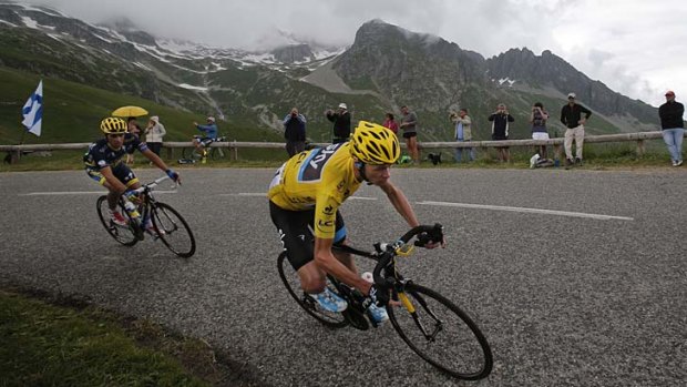 Still chasing: Race leader Christopher Froome and Spain's Alberto Contador, left, speed down Madeleine pass during the 19th stage of the Tour de France.