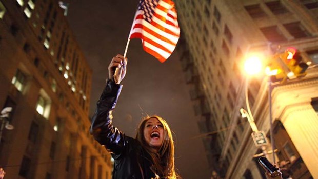 A woman  waves an American flag as she joins a crowd celebrating the death of bin Laden.