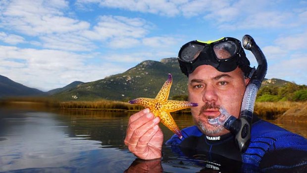 Matt Hoskins of Parks Victoria with a Northern Pacific Seastar in Tidal River .