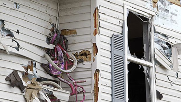 A child's bicycle impaled into the side of a home after a tornado hit in Millbury, Ohio.