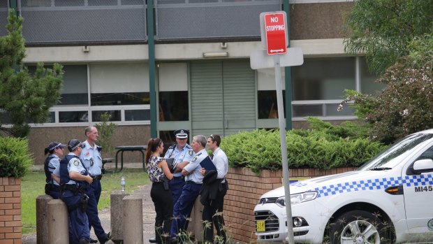 Police gather outside Woolooware High School, which also received a bomb threat.