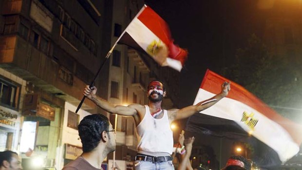Celebration: An anti-Mursi protester dances in delight after the removal from office of Egypt's deposed President Mohamed Mursi.