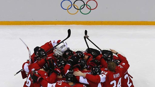 Canada's players huddle after defeating Sweden.