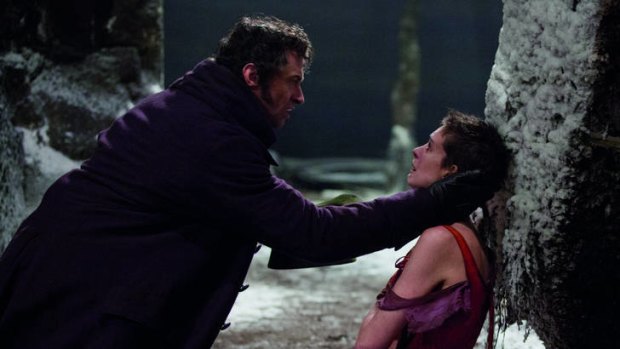 Anne Hathaway as Fantine and Hugh Jackman as Jean Valjean in <i>Les Miserables</i>.