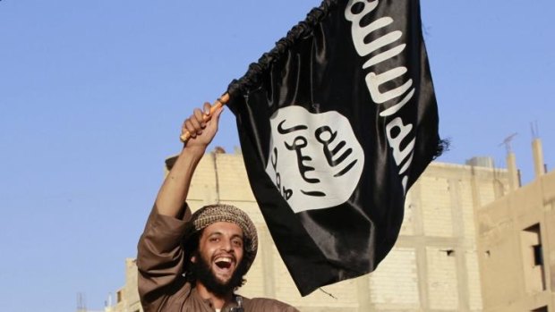 A militant Islamist fighter waving a flag.