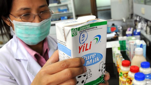 A government laboratory technician of the Bureau of Food and Drugs tests milk products.