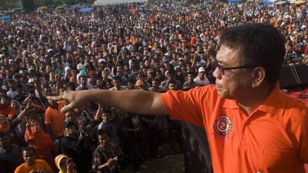 Irwandi Yusuf, who is seeking to be elected to a second term as governor of Aceh, speaks to supporters at a campaign rally.