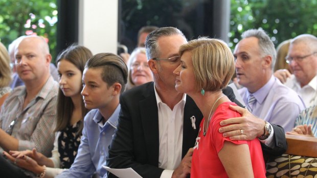 Remembered: Kathryn Szyszka is comforted by her husband Walter Szyska after speaking at the first community memorial service for her sister, Anita Cobby.