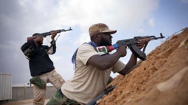 Revolutionary fighters take up positions in Sirte, Libya as new regime forces pressed their campaign to capture it from fiercely determined loyalists.