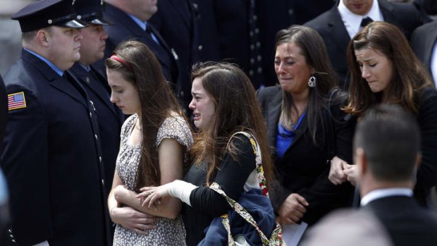 Raw pain and emotion: Mourners leave the funeral for Boston marathon bombing victim Krystle Campbell, 29, on Monday.
