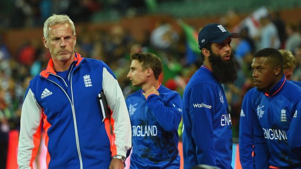 England coach Peter Moores with players after the team lost to Bangladesh.