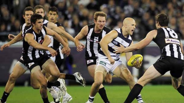 Gary Ablett looks to elude a pack of Magpies when the teams met in round 9 this season.