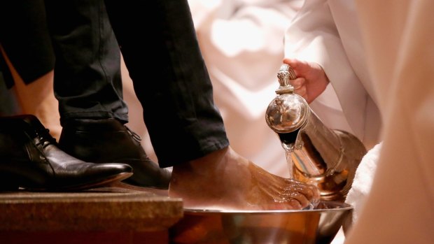  The Reverend Canon Heather Patacca washes feet during the Choral Eucharist on Thursday at St Paul's Cathedral.