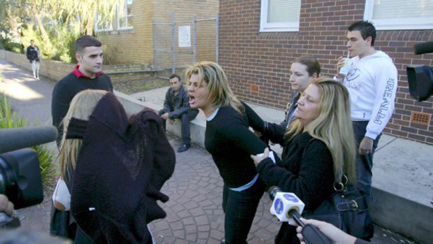 Fury ... Zervas's grief-stricken mother, Frederica Bromwich, restrains a friend who clashed with supporters of Mick Hawi outside Kogarah Local Court yesterday afternoon.