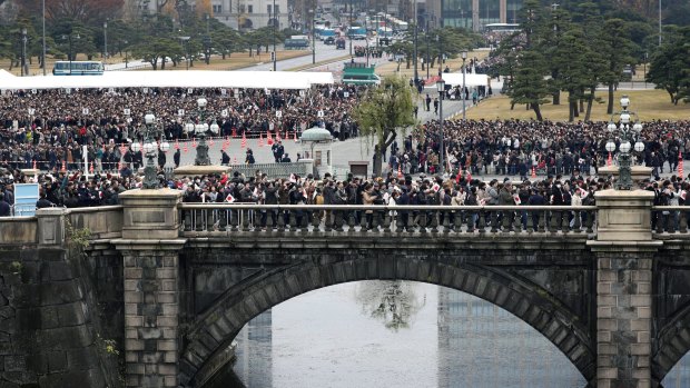 Well-wishers cross a bridge to head to Emperor's 85th birthday celebration at the Imperial Palace in Tokyo on December 23.