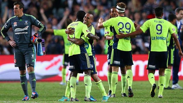 Archie Thompson celebrates with teammate Adama Traore after Victory won the game.