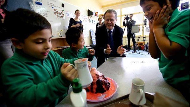Bill Shorten MP watches a volcano experiment on a visit to the Western Autistic School in Niddrie, Melbourne.