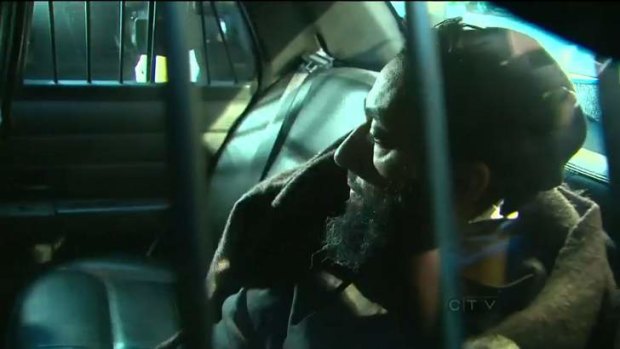 Raed Jaser arrives to court in the back of a police car in Toronto. Jaser of Toronto, 35, and Chiheb Esseghaier, 30, face charges that include conspiring "with each other to murder unknown persons for the benefit of, at the direction of, or in association with a terrorist group."