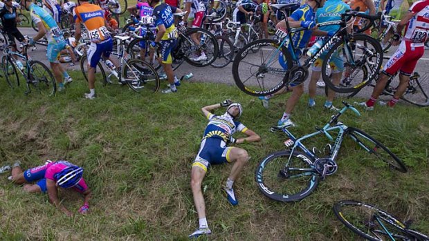 Stack in the middle ... Dutch rider Wouter Poels lies at the side of the road after a crash involving 30 riders on stage six.