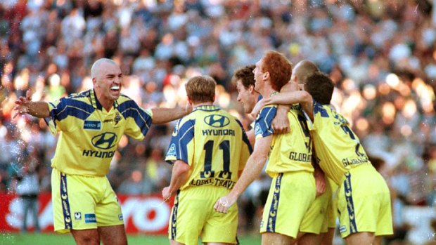 Brisbane Strikers players celebrate their 1997 NSL Grand Final victory at Suncorp Stadium.