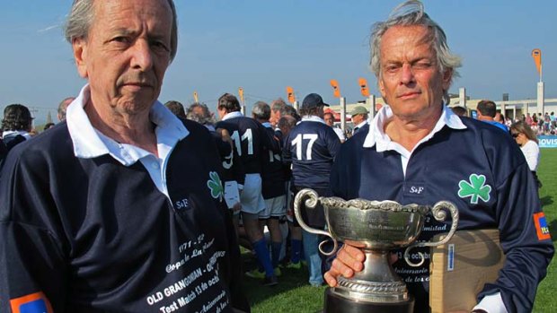 Daniel Fernandez, 66, left, and Eduardo Strauch, 65, hold a commemorative trophy.