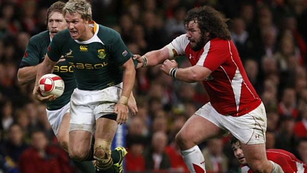 South Africa's Jean de Villiers escapes the tackle of Wales' Adam Jones.