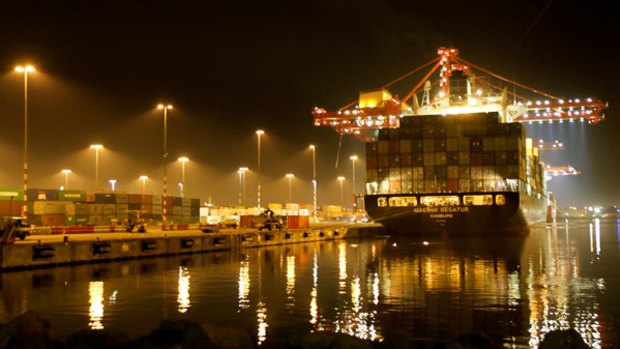 Floodlights are no guarantee of security as a container ship's freight is unloaded at the Melbourne docks.