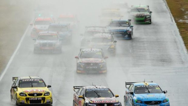 Slippery: Jamie Whincup, centre, leads Scott McLaughlin, right, and eventual winner Shane Van Gisbergen.
