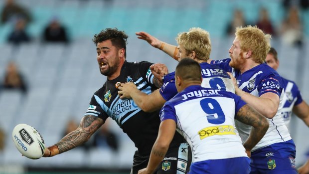 Andrew Fifita of the Sharks passes as he is tackled.