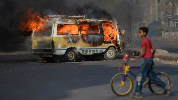 A bus burns on the streets of Karachi after news reached the city of the London arrest of political leader Altaf Hussain.