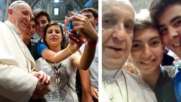 Selfie: Pope Francis has his picture taken inside St. Peter's Basilica with young pilgrams.