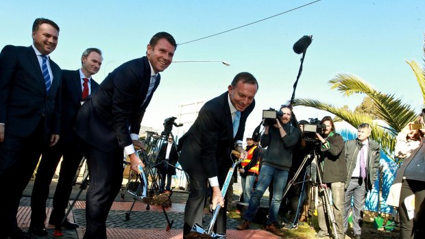 Digging in: Mike Baird and Tony Abbott turn the first sods on the interchange upgrade. 