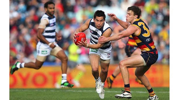 Geelong's Matthew Stokes tries to break a tackle.
