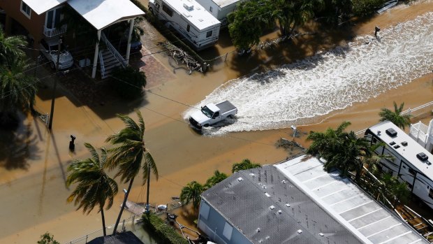 A truck drives through a flooded street in the aftermath of Hurricane Irma in Key Largo, Florida.