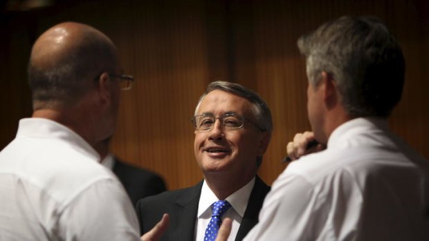 Treasurer Wayne Swan speaks to journalists as he walks through the Budget lock-up in Parliament House.