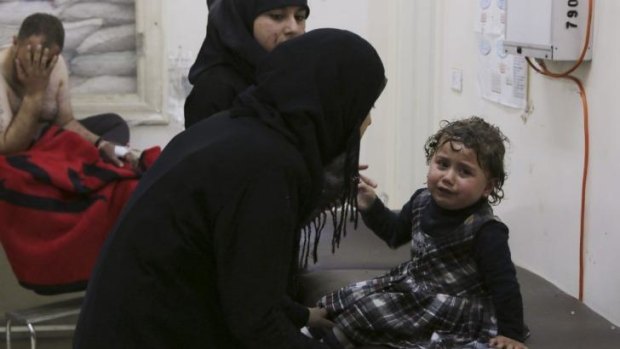 The injured child is comforted at a clinic in the aftermath of the bombing on April 2.