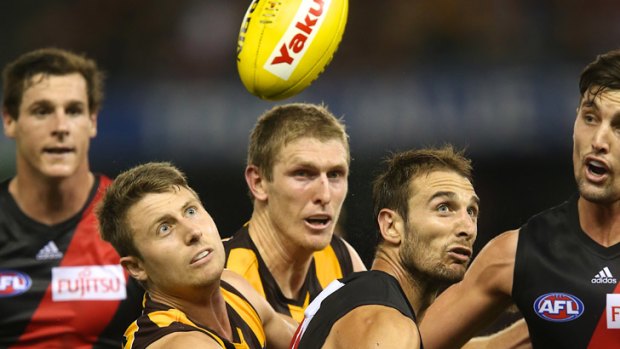 Eyes on the ball... Hawthorn's Liam Shiels and Essendon's Jobe Watson compete for possession.