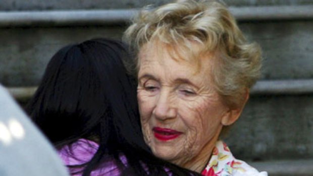 The mother in law of murdered business man, Michael McGurk, hugs someone, at the Cremorne family home.