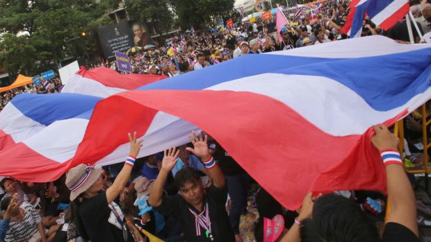 Anti-government protesters move a giant national flag during a rally in Bangkok, Thailand.