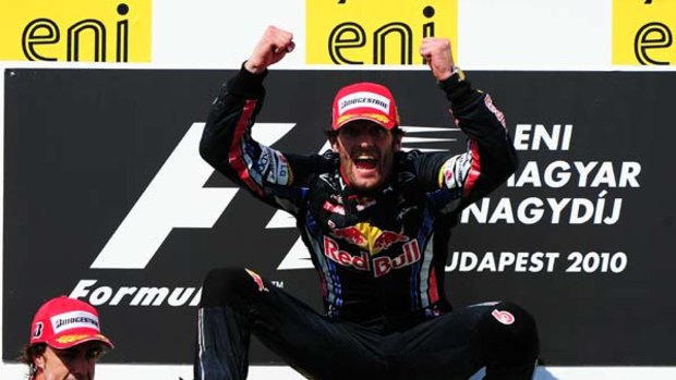 Mark Webber of Australia and Red Bull Racing celebrates on the podium after winning the Hungarian Formula One Grand Prix.