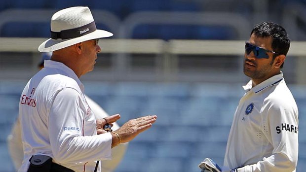 Umpire Daryl Harper with Mahendra Singh Dhoni explaining to the Indian captain that Praveen Kumar could not bowl again in the first innings of the First Test against the West Indies last week.