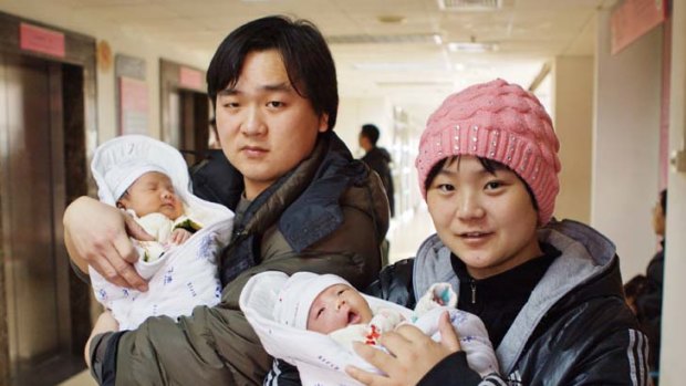 Fortunate pair ... newborn twins Liu Yibing and Liu Yiqing with their parents.