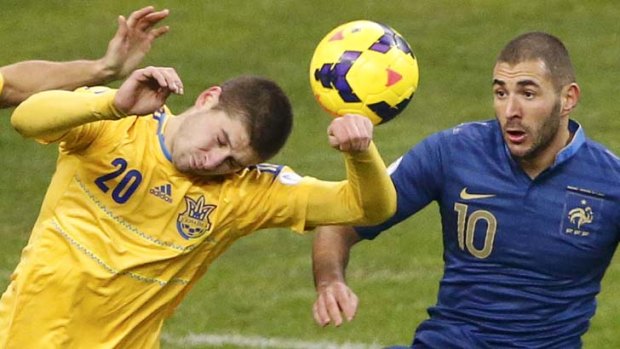 France's Karim Benzema challenges Ukraine's Yaroslav Rakitskyy.