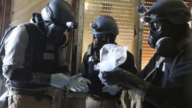 A UN chemical weapons expert holds a plastic bag containing samples from one of the sites of an alleged chemical weapons attack in  Damascus in  August.