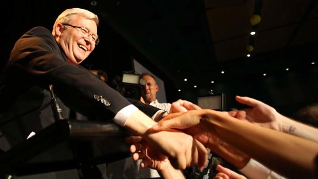 Kevin Rudd shakes hands with supporters as he concedes defeat.