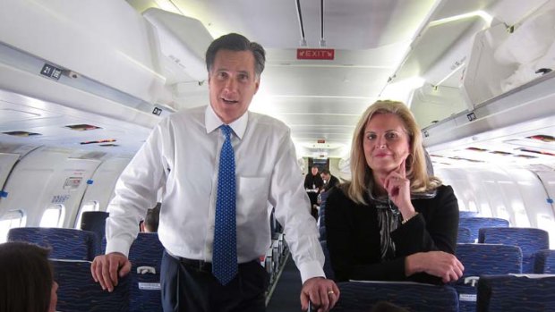 "A winner, with reservations ... Mr Romney, with his wife Ann behind him, speaks with reporters on the campaign plane in Ohio".