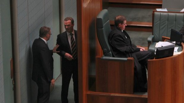 Anthony Albanese (left) and Christopher Pyne lurk theatrically behind Speaker Peter Slipper's chair during question time in Parliament yesterday.