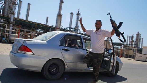 A rebel fighter celebrates in Zawiyah.