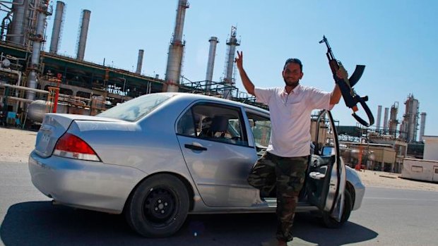 A rebel fighter celebrates in Zawiyah.