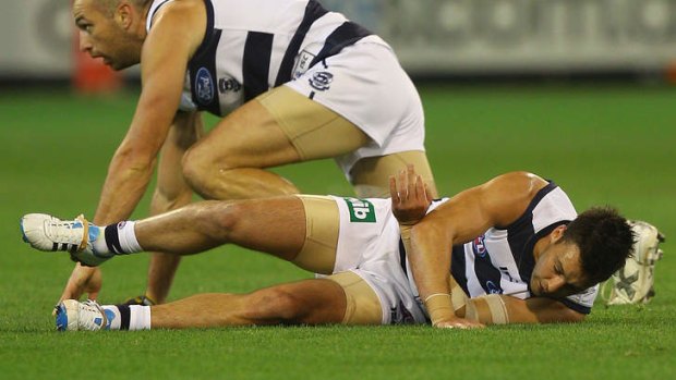 Jimmy Bartel lays on the ground after taking a heavy hit to the head.